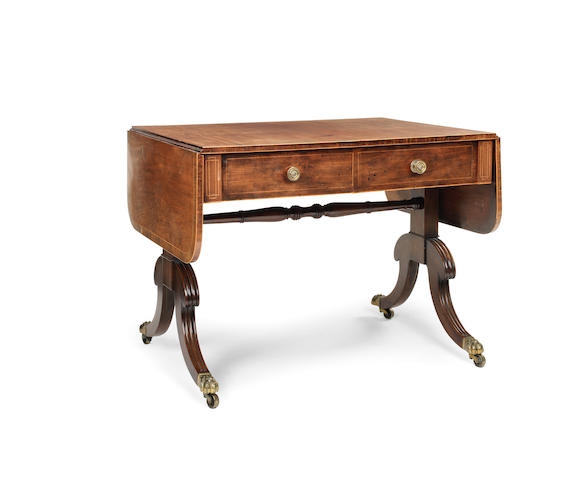 Appraisal: A Regency mahogany and rosewood crossbanded sofa table the rounded