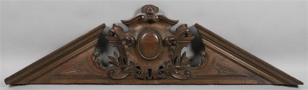 Appraisal: CARVED WALNUT CLASSICAL STYLE BROKEN ARCH DOOR PEDIMENT having a