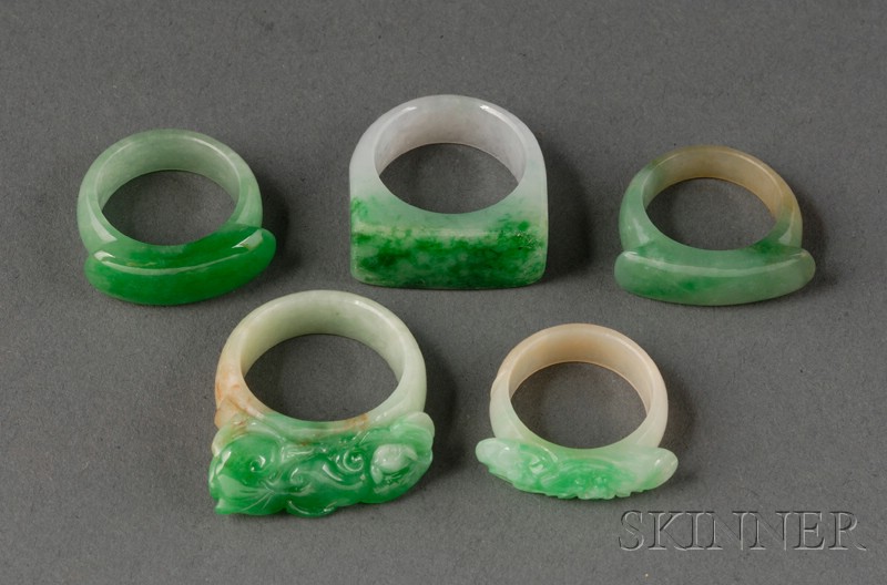 Appraisal: Five Jade Saddle Rings China th century with areas of