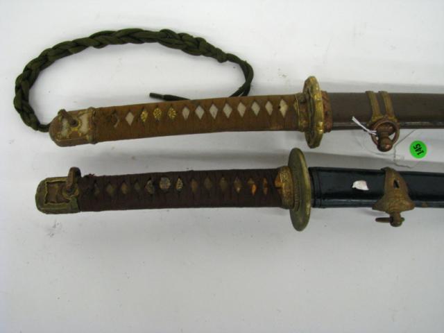 Appraisal: Two Japanese style vintage swords both with leather scabbards no