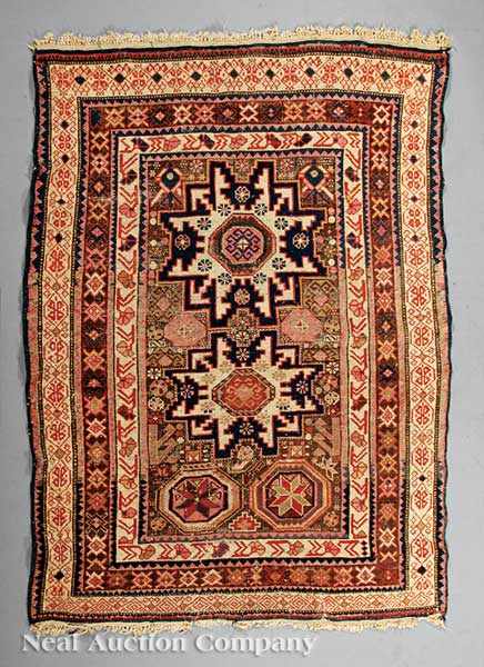 Appraisal: An Antique Persian Rug blue ground triple lozenge central design