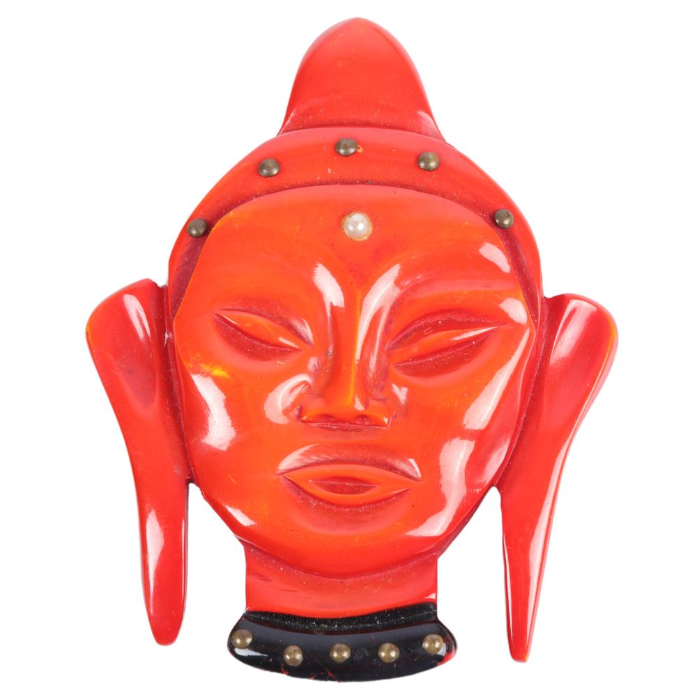 Appraisal: BAKELITE RED ASIAN FACE BUDDHA PIN WITH FAUX PEARL AND