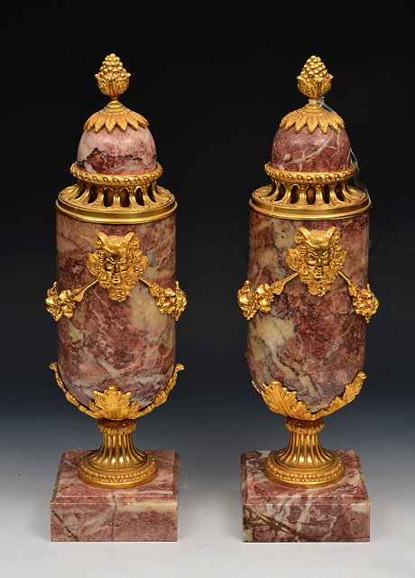 Appraisal: A PAIR OF ROUGE MARBLE AND ORMOLU MOUNTED URNS with