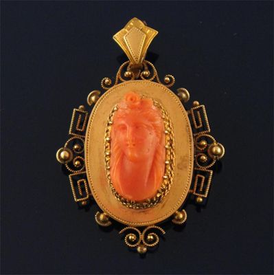 Appraisal: A th century oval gold pendant set with a coral