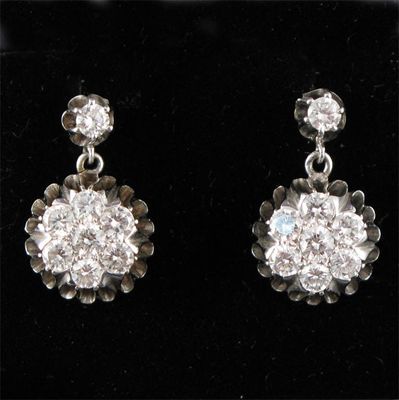 Appraisal: A pair of diamond cluster earrings Set in white gold