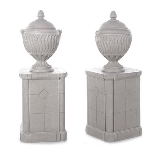 Appraisal: Pair faux cast-stone covered urns on pedestals overall H Sq