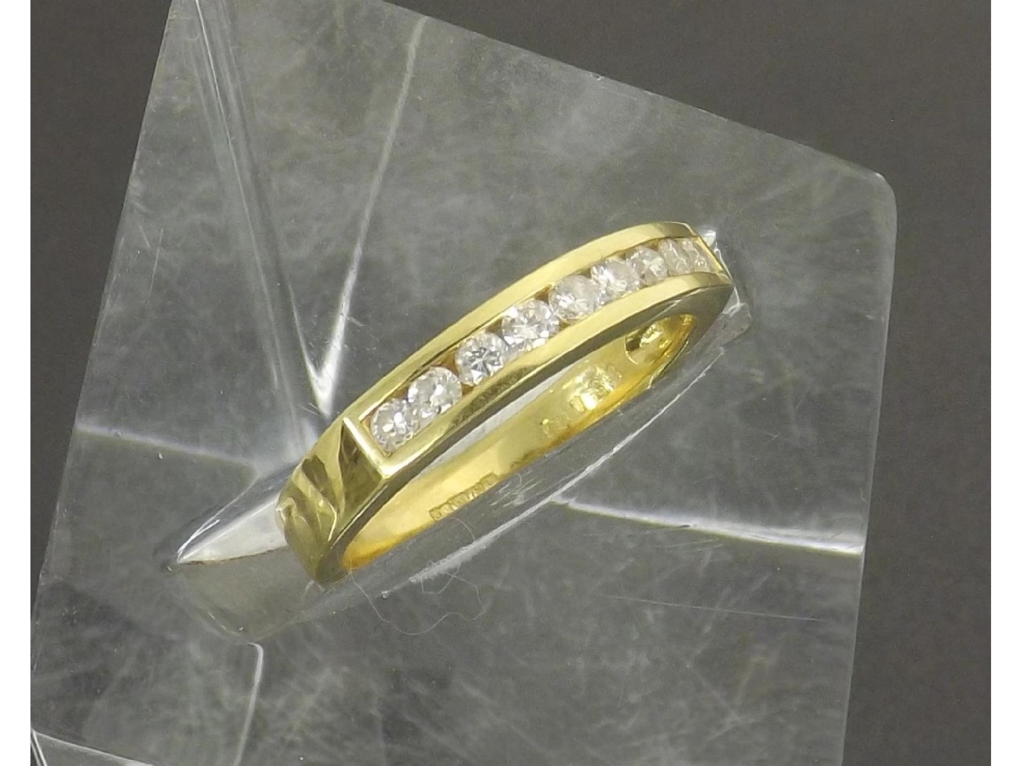 Appraisal: - a ct yellow gold nine stone channel set brilliant-cut