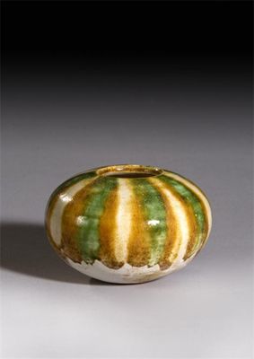 Appraisal: A small Chinese pottery sancai-glazed ointment pot Tang dynasty -