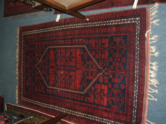 Appraisal: A Persian blue ground rug with stylised leaf designs to