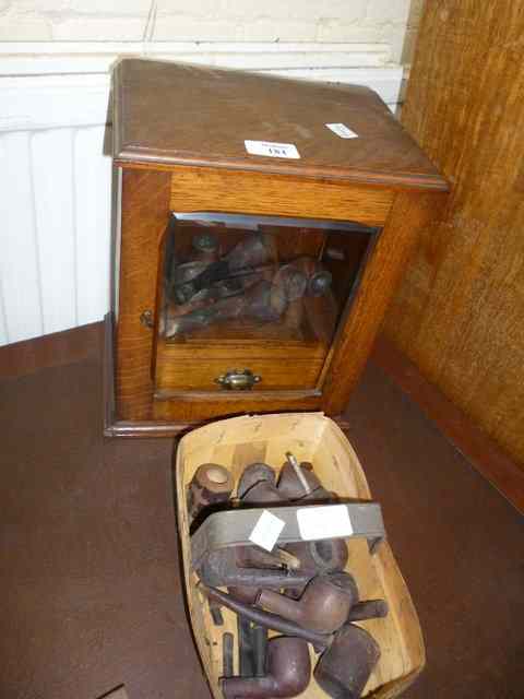 Appraisal: AN OAK TOBACCO CABINET with single glazed door wide together