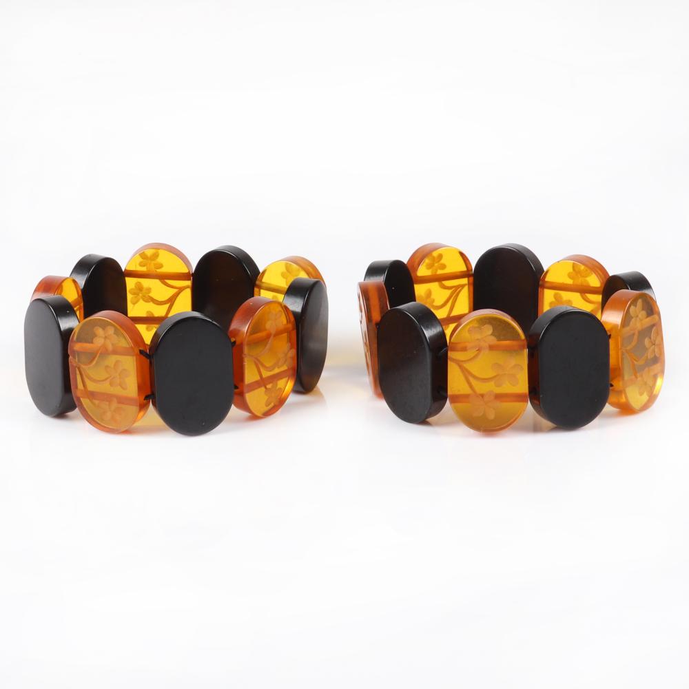 Appraisal: PAIR OF BAKELITE STRETCH BRACELETS WITH CARVED OVAL FLORAL APPLE