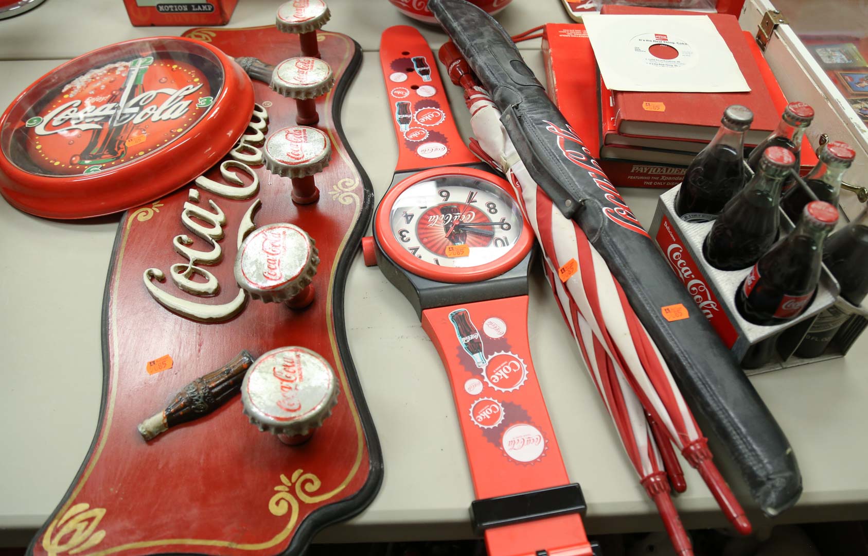 Appraisal: Assortment of Coca-Cola collectibles including pool stick books clocks umbrellas