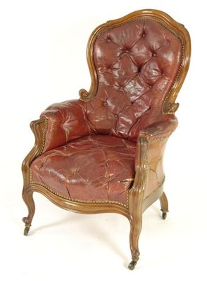 Appraisal: A Victorian mahogany button upholstered red leather armchair on moulded