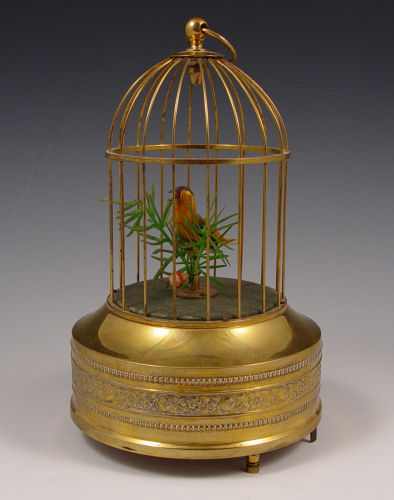 Appraisal: SINGING BIRD AUTOMATON IN CAGE Brass decorated frame and base