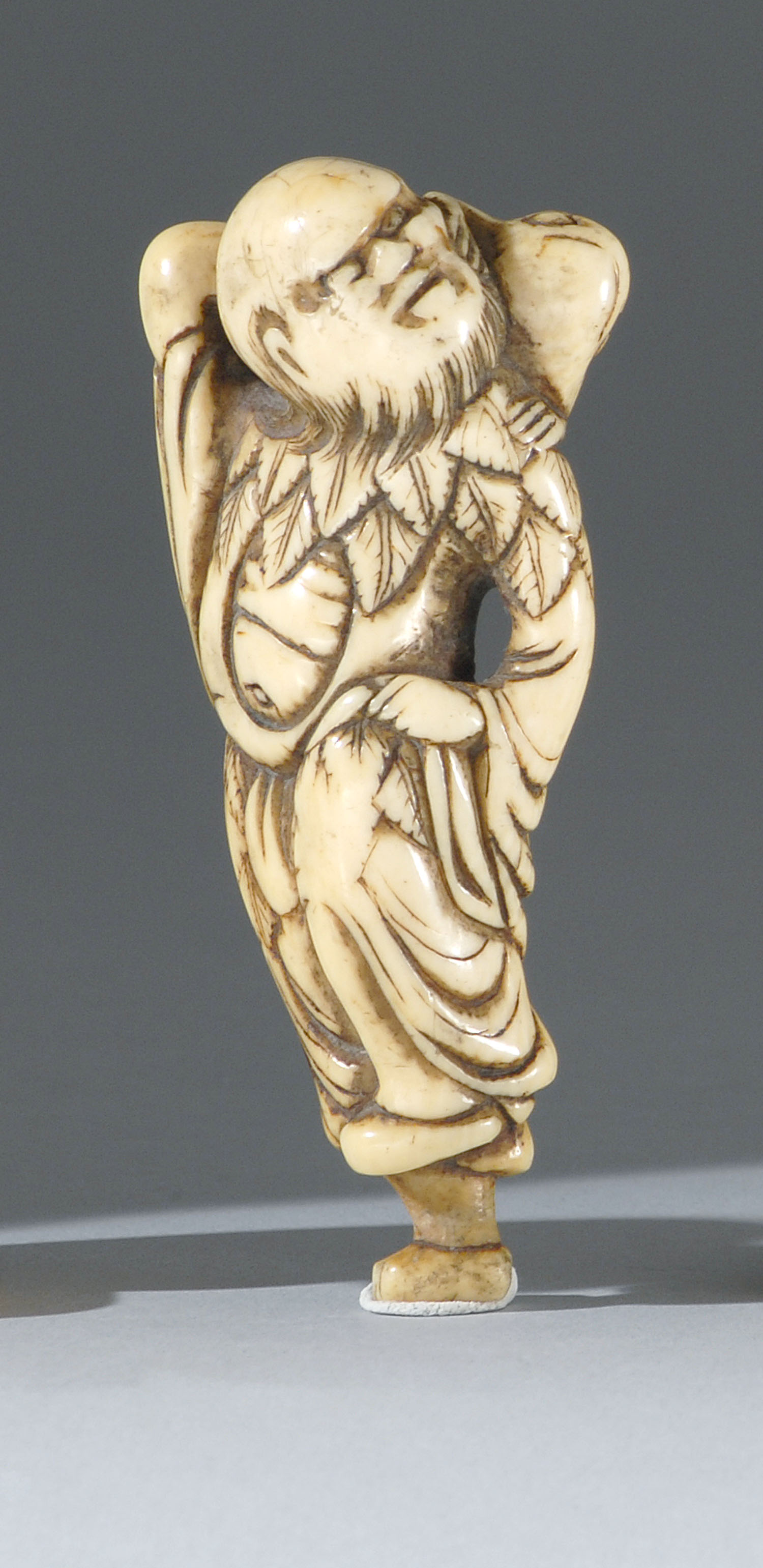 Appraisal: IVORY NETSUKE th CenturyIn the form of Gama Sennin standing