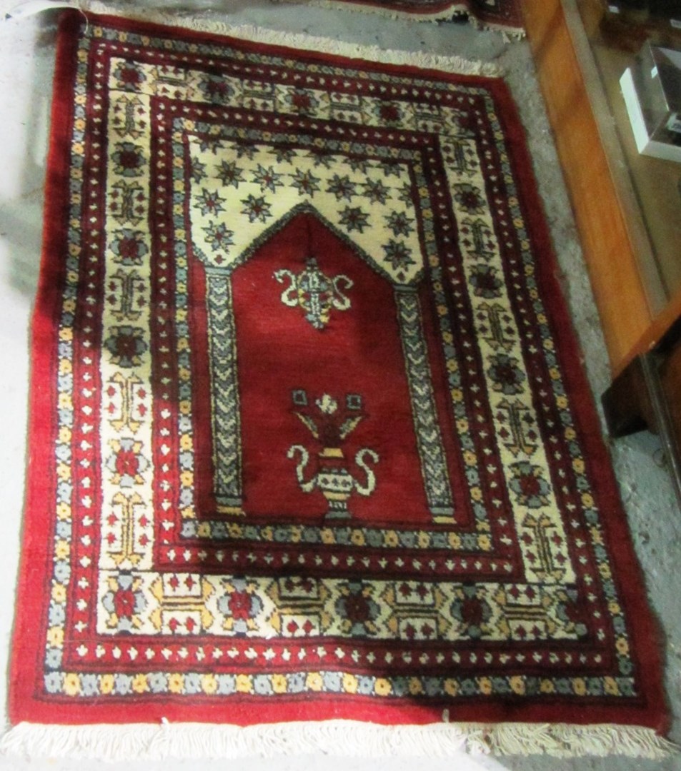 Appraisal: A Turkish prayer rug the madder mehrab with ivory arch