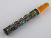 Appraisal: A Russian cloisonne enamelled silver cigarette holder with amber mouthpiece