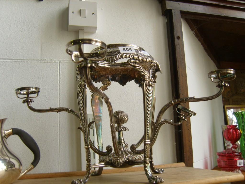 Appraisal: A silver plated table centre raised on four paw supports