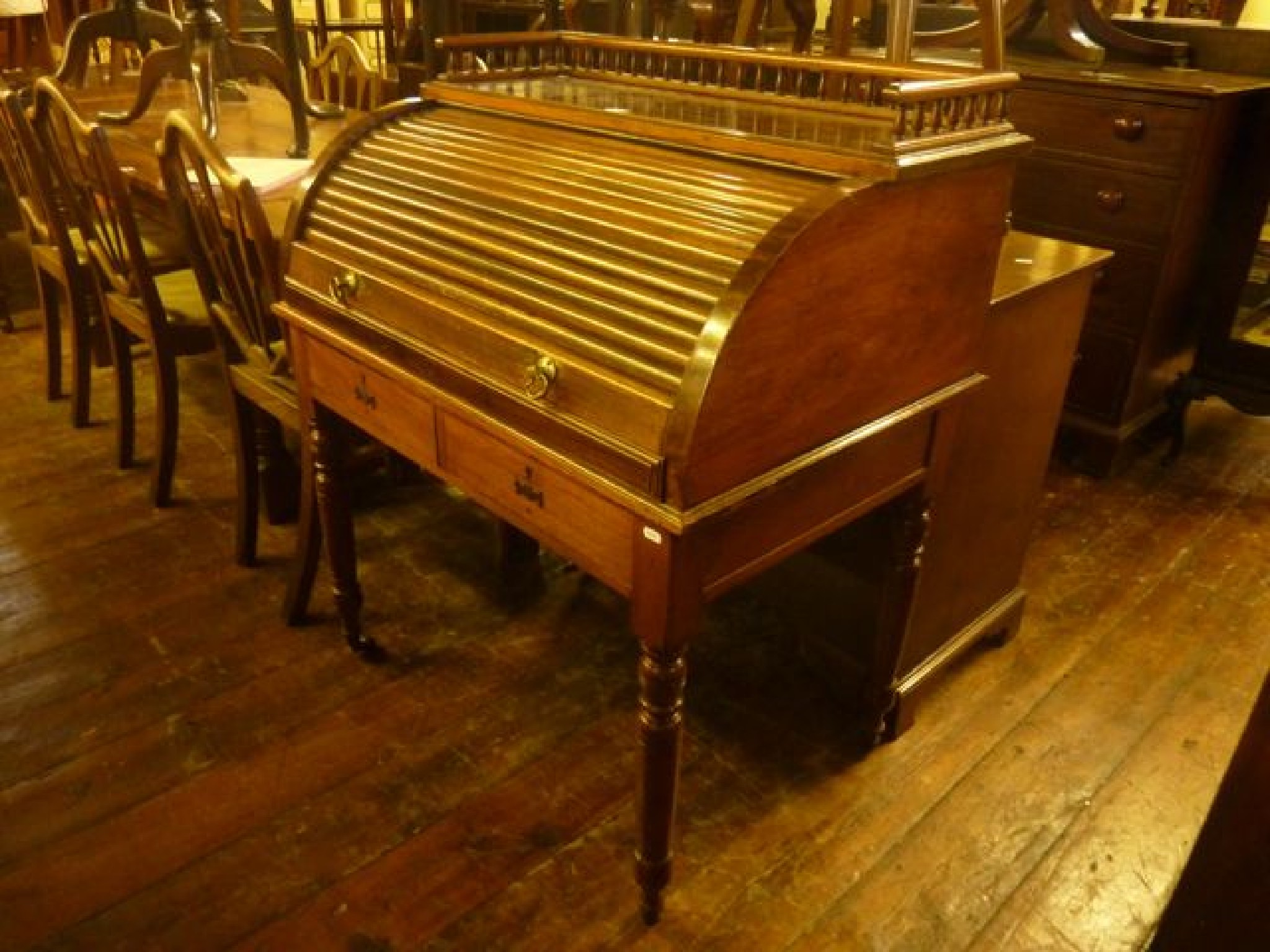 Appraisal: A late Victorian Edwardian walnut writing desk with raised threequarter