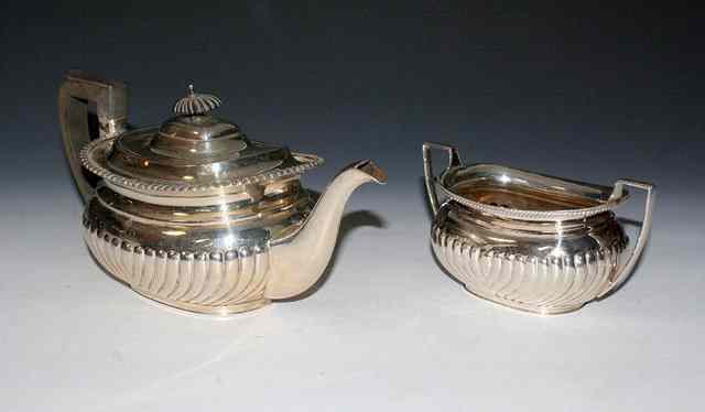 Appraisal: AN OVAL SILVER TEAPOT with fluted lower body gadrooned edge