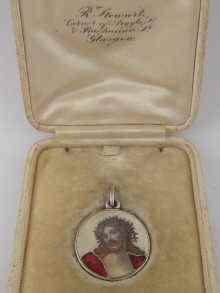 Appraisal: A silver pendant medallion the obverse with finely enamelled head