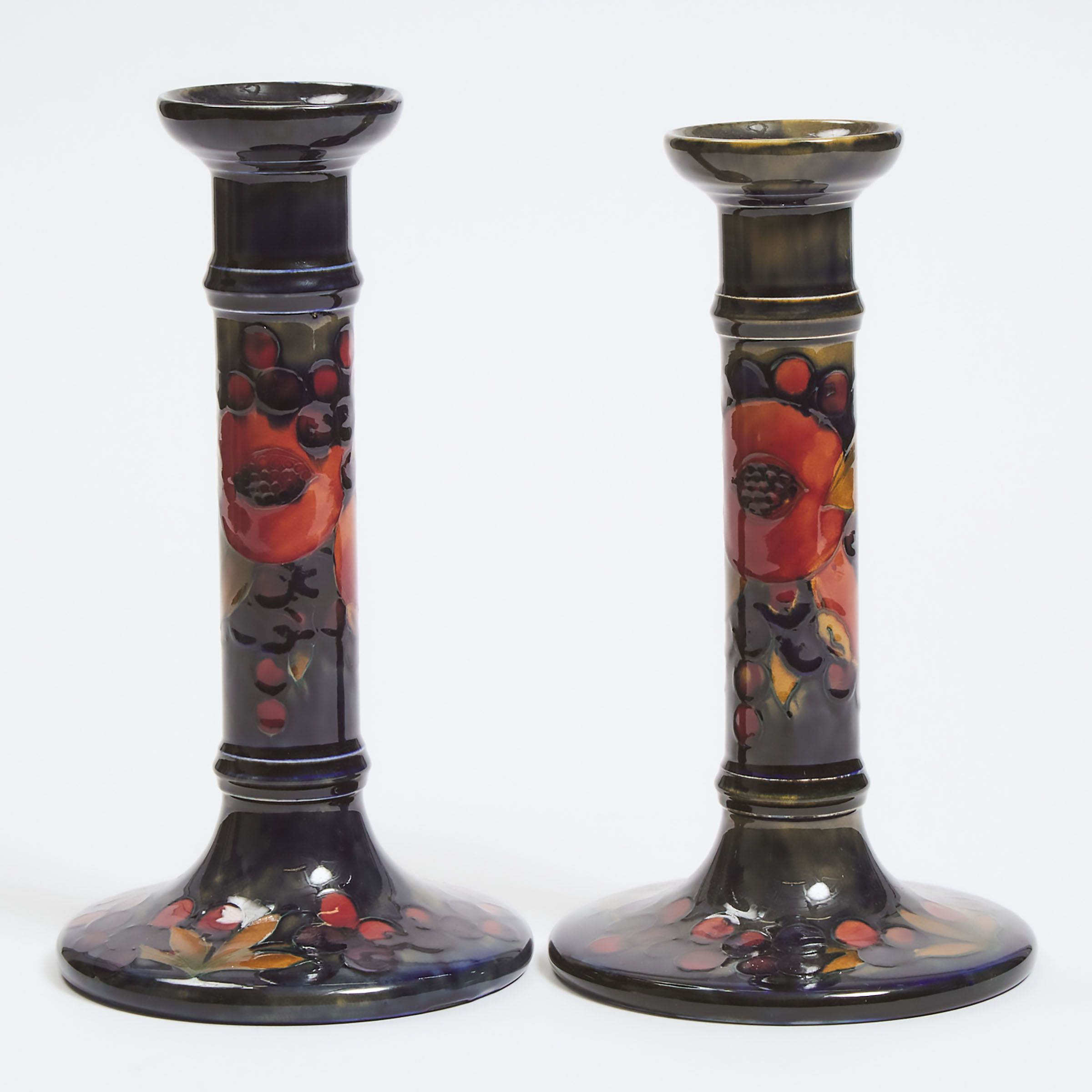 Appraisal: Two Large Moorcroft Pomegranate Table Candlesticks c height in cm