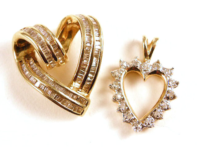 Appraisal: TWO DIAMOND AND YELLOW GOLD PENDANTS both heart pendants are