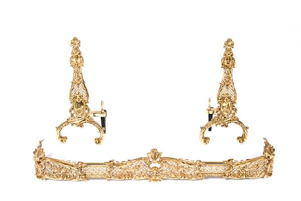 Appraisal: A pair of brass andirons and matching fire fender height