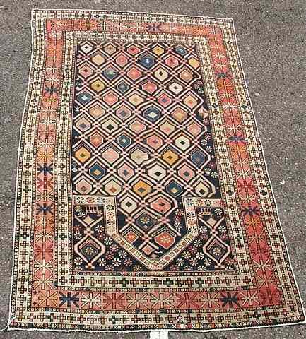 Appraisal: AN ANTIQUE CAUCASIAN PRAYER RUG lattice field with geometric motifs