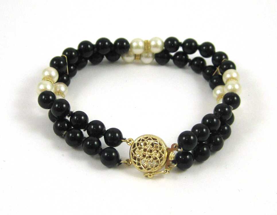 Appraisal: BLACK ONYX PEARL AND YELLOW GOLD BRACELET The double strand