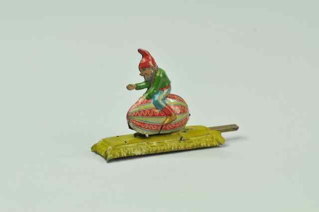 Appraisal: GNOME ON EGG ARTICULATED PENNY TOY Meier colorful lithographed tin