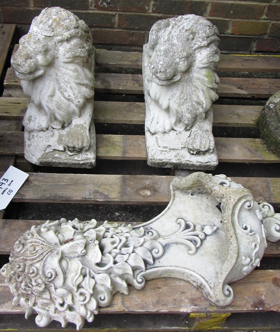 Appraisal: A pair of reconstituted stone figures of recumbent lions cm