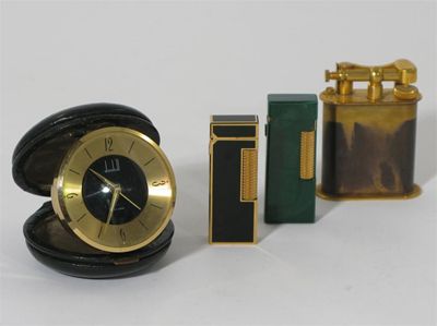 Appraisal: A Dunhill travel alarm clock circular form with Swiss made