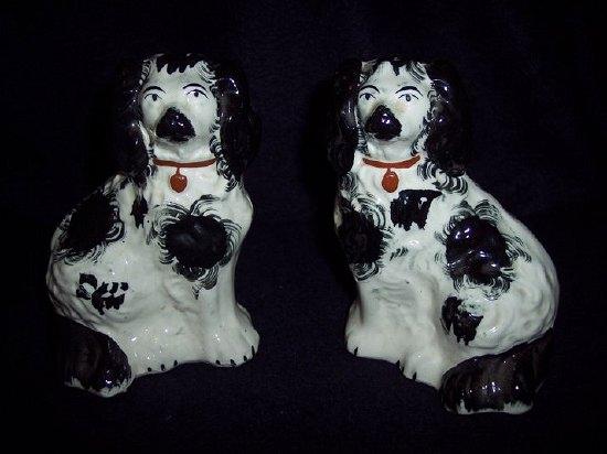 Appraisal: A pair of Staffordshire black and white dogs with brown