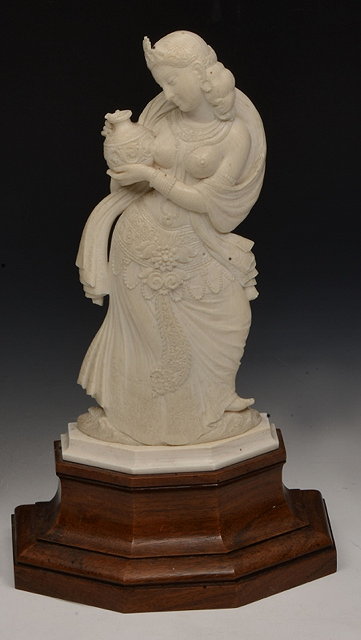 Appraisal: AN EASTERN IVORY FIGURE in the form of a semi-clad