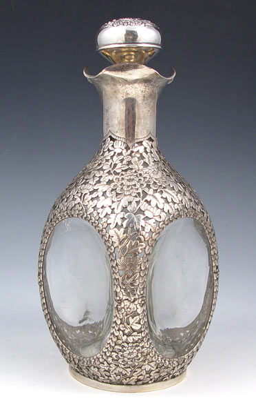 Appraisal: CHINESE SILVER OVERLAY DECANTER Pierced openwork floral design hallmarked with