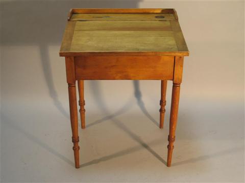 Appraisal: AMERICAN FRUITWOOD SLANTED SCHOOL DESK Nineteenth century the hinged writing