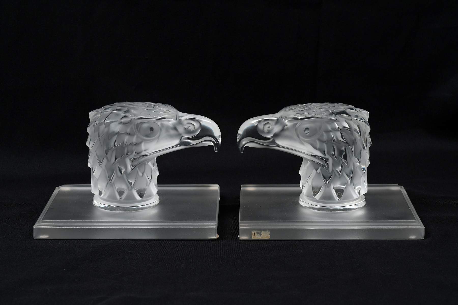 Appraisal: LALIQUE EAGLE'S HEAD AUTOMOBILE HOOD ORNAMENTS Pair of French Lalique