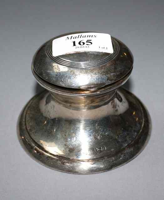 Appraisal: A SILVER CAPSTAN INK STAND with reeded decoration matching hinged