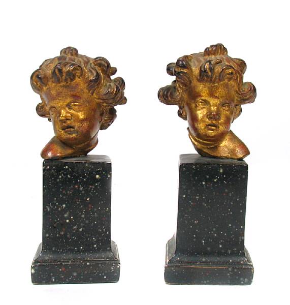 Appraisal: A pair of Italian gilt and faux porphyry cherub heads