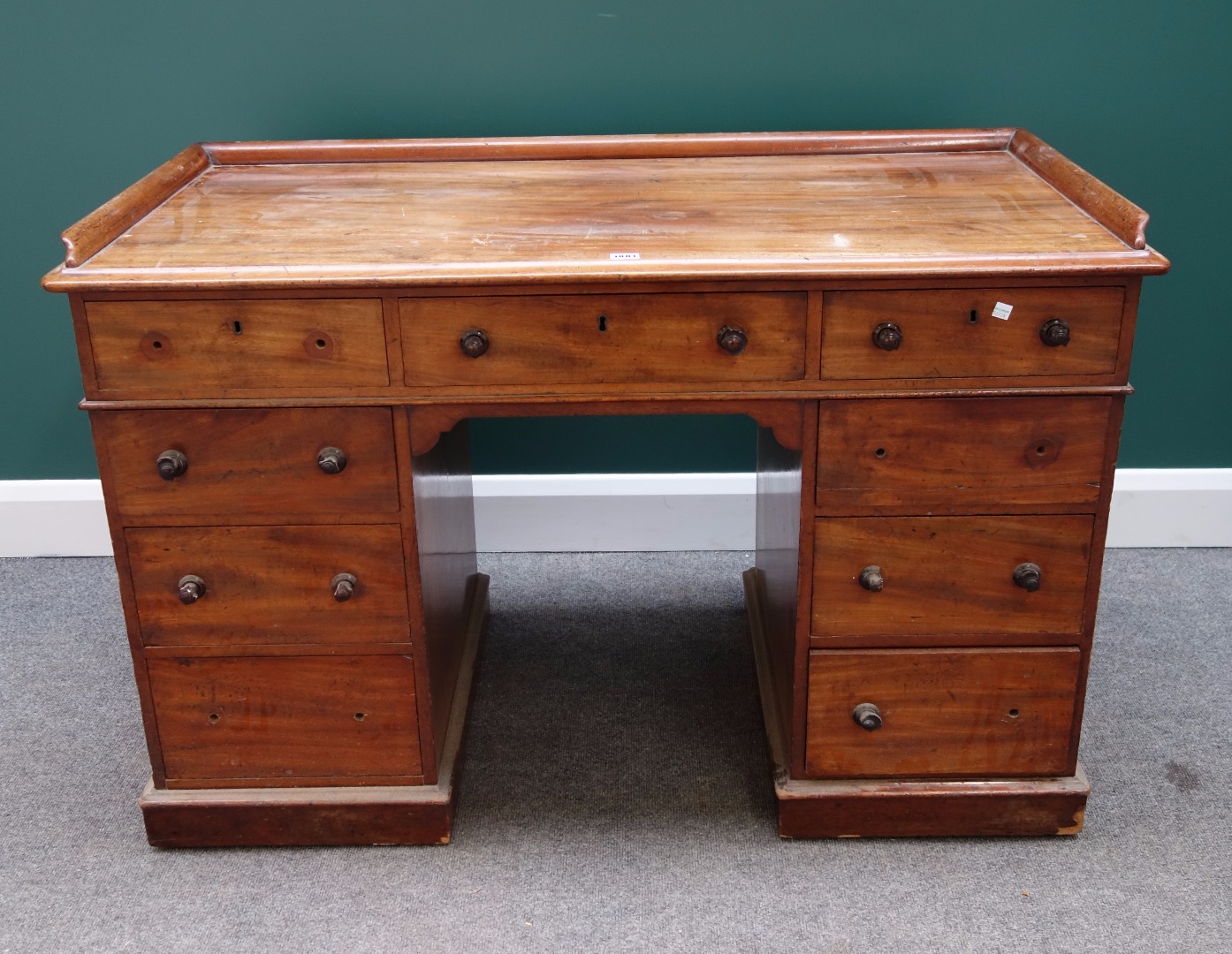 Appraisal: A Victorian mahogany writing desk with galleried top over nine