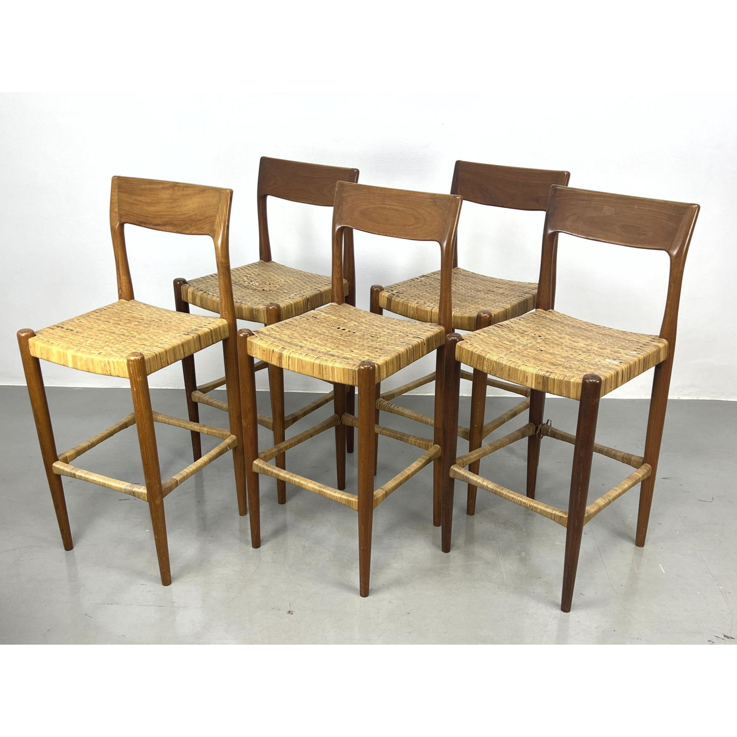 Appraisal: Set Danish Modern Teak Bar Stools Woven Rattan Seats and