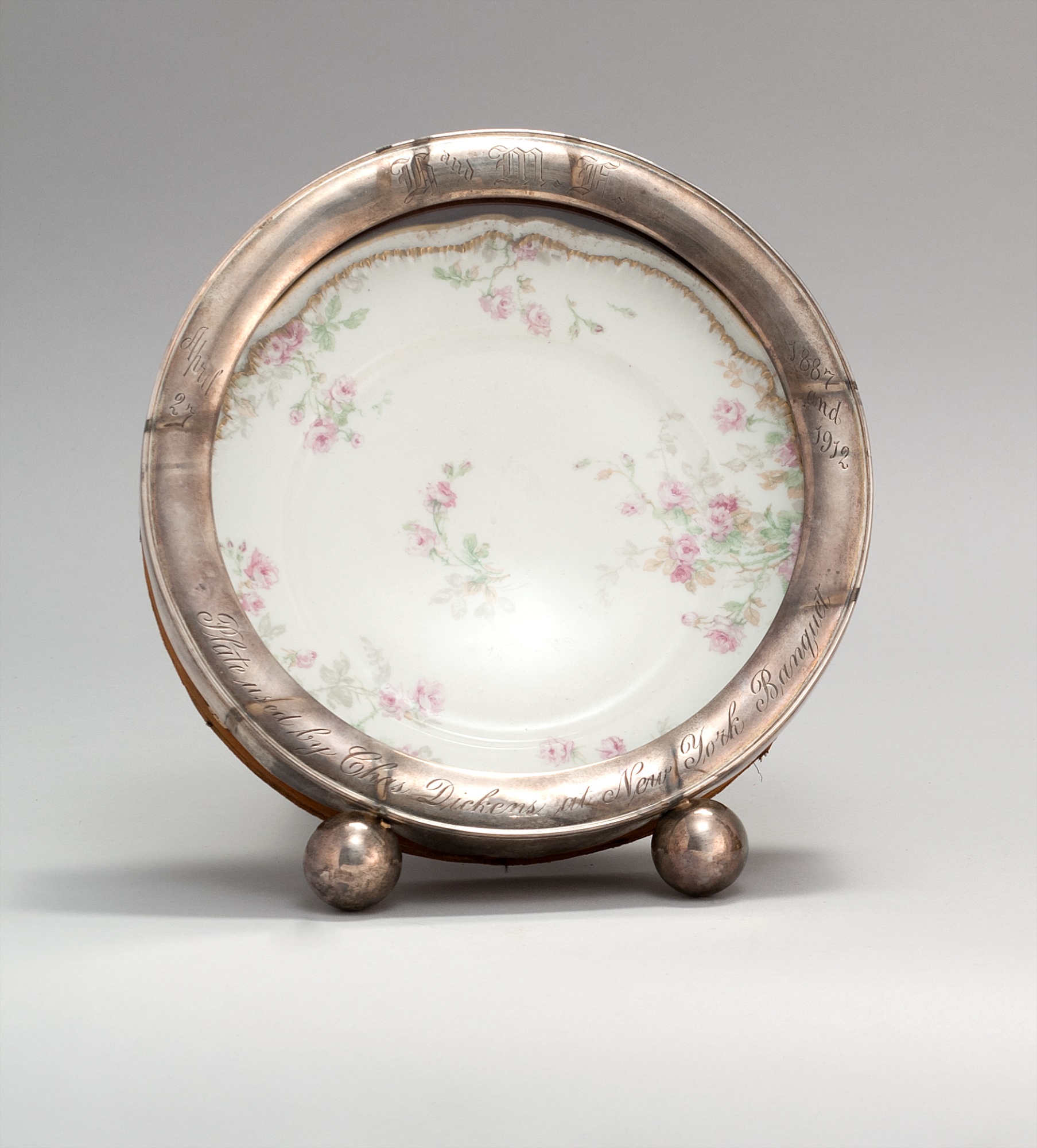 Appraisal: STERLING SILVER CIRCULAR FRAME Housing a Limoges porcelain plate Frame