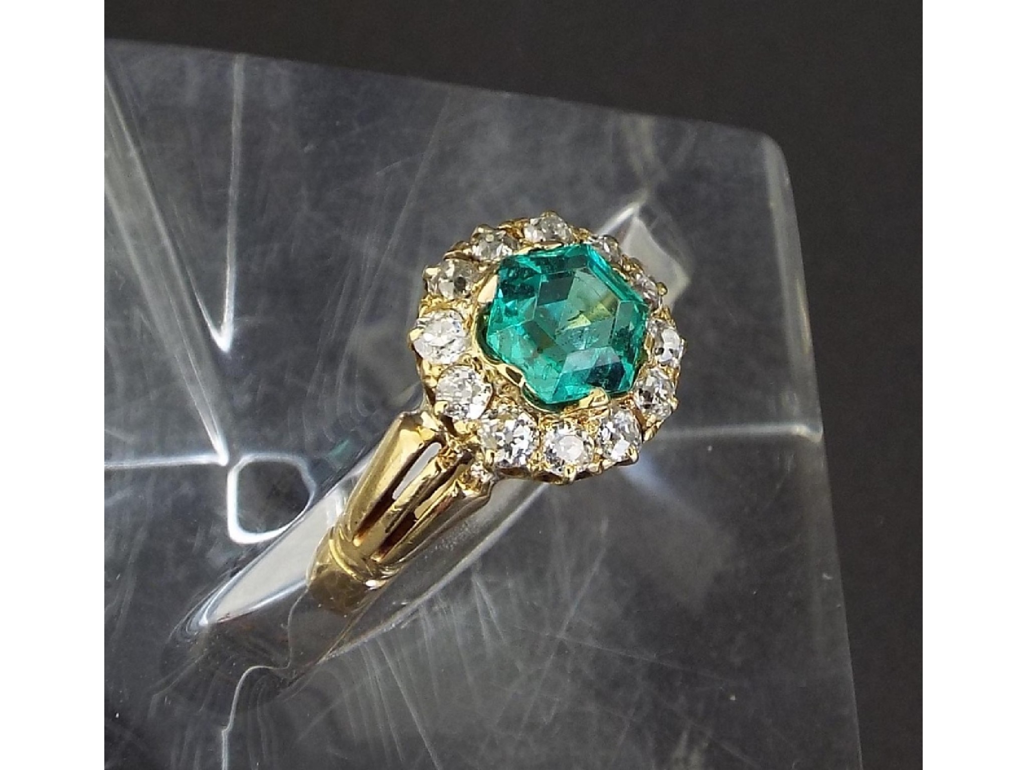 Appraisal: Emerald and diamond circular cluster ring the emerald ct approx