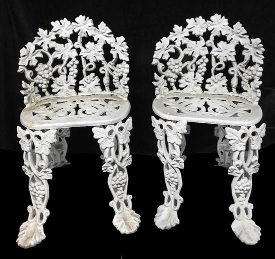 Appraisal: Pair white painted cast-iron garden chairs pierced grape cluster leaf