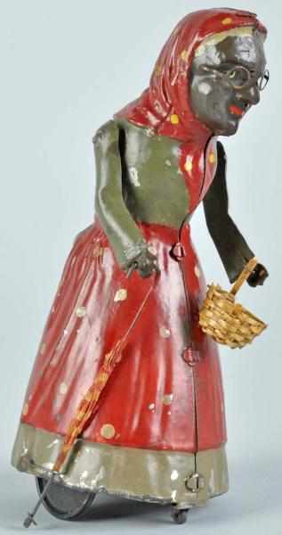 Appraisal: Tin Handpainted Woman with Basket Wind-Up Toy Description American Working