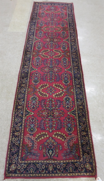 Appraisal: HAND KNOTTED ORIENTAL RUNNER Indo-Sarouk floral sprig pattern on red