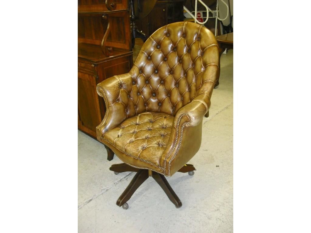 Appraisal: th century style button-back leather swivel chair the raised arched