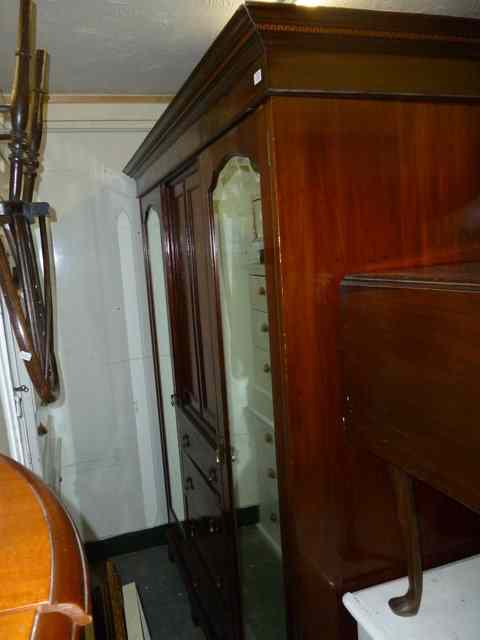 Appraisal: AN EDWARDIAN MAHOGANY TRIPLE WARDROBE the central section with twin