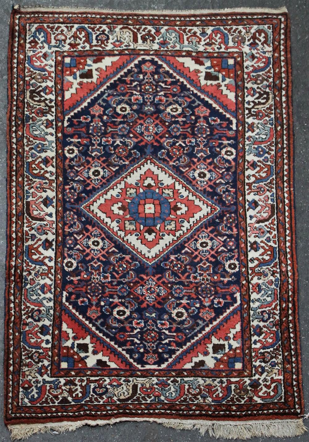 Appraisal: SMALL PERSIAN WOOL SAROUK RUG having a diamond medallion central